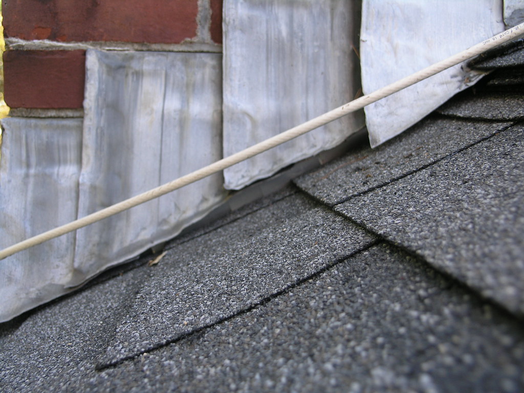 a close-up of the flashing on a roof near a chimney